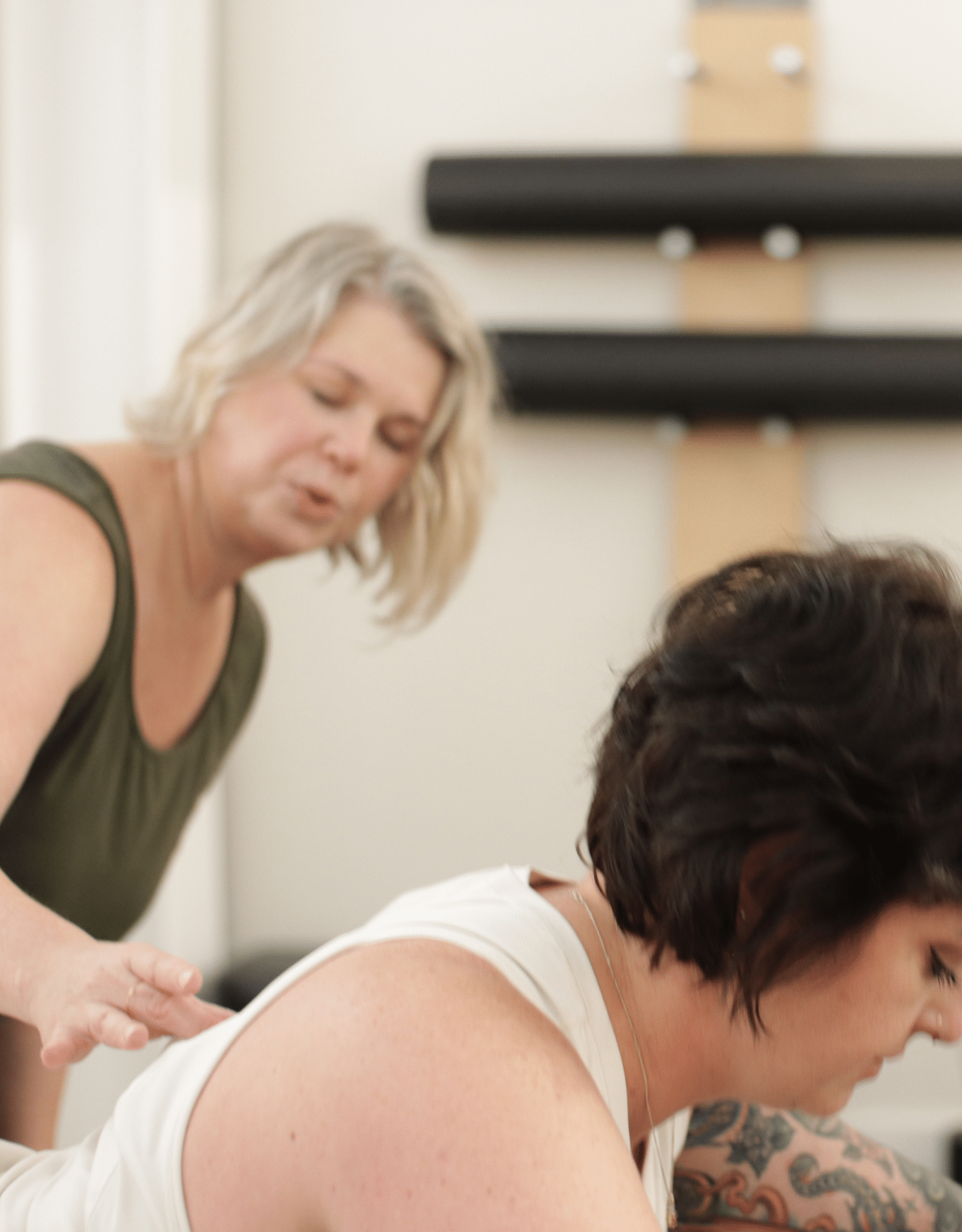 Pilates instructor guiding a woman on the reformer at Marathon Pilates in Nashville